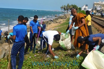 Naval personnel pitch in with beach cleaning